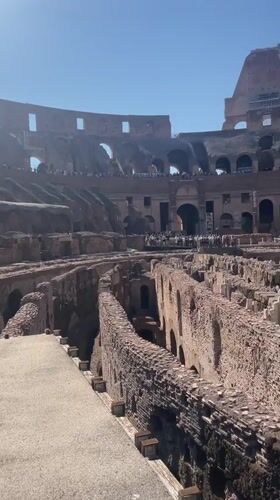 Tourists visit Rome's Colosseum on sunny afternoon