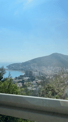 Vehicle passenger films scenic view overlooking Budva coastal town