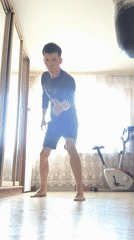 Man performs burpee exercise in bedroom setting