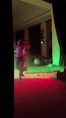 Two women dance on lit stage in Nova Zagora
