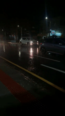 Vehicles navigate wet streets during night in Curitiba