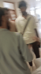 Men gather in medical facility hallway in Peshawar