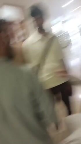 Men gather in medical facility hallway in Peshawar