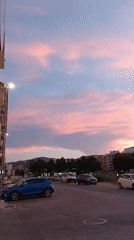 Dusk settles over Oliva: streets, sky, and a sleeping cat