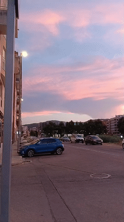 Dusk settles over Oliva: streets, sky, and a sleeping cat