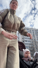 Mother and baby visit Moscow playground on spring morning