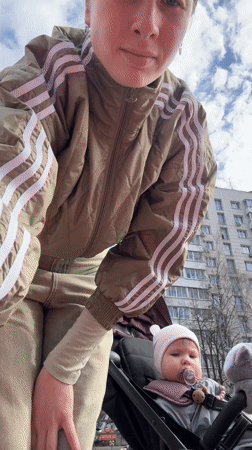 Mother and baby visit Moscow playground on spring morning