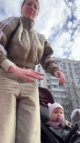 Mother and baby visit Moscow playground on spring morning