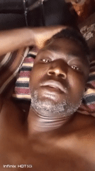 Man captures multiple selfies while lying in bed