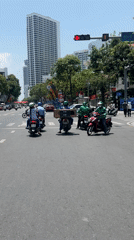 Morning street scenes captured in Nha Trang with traffic, flags