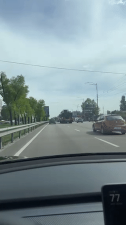 Driver records routine travel on Ukrainian road during overcast day
