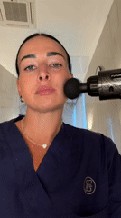 Woman uses facial massage gun at Saint Petersburg spa facility