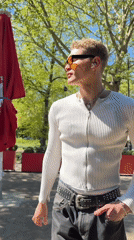 Man in orange sunglasses spotted outdoors, entering London subway