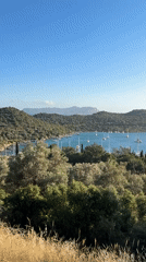 Sailboats anchor in Kaş harbor amid Mediterranean scenery