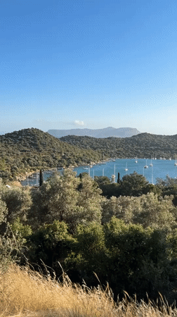 Sailboats anchor in Kaş harbor amid Mediterranean scenery