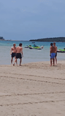 Morning beach soccer and vendor activity in Baan Chaweng