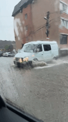 Street flooding reaches mid-tire level in Novyi, Russia