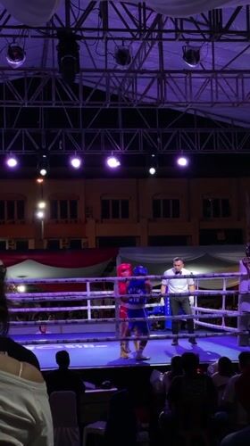 Outdoor boxing and fireworks mark a nighttime event in Manado