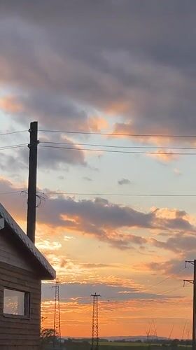 Dramatic sunset documented over wooden cabin in Pchelnik, Bulgaria