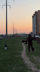 Woman and child walk dirt path in Odintsovo