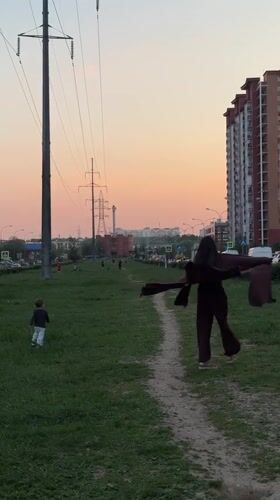 Woman and child walk dirt path in Odintsovo