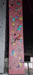 Indoor climbing session on a red wall, various routes tackled