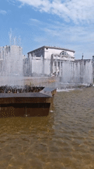 Morning pedestrians gather around fountain in Yekaterinburg square