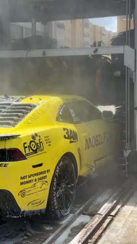 Yellow Camaro gets car wash in Monopoli, Italy