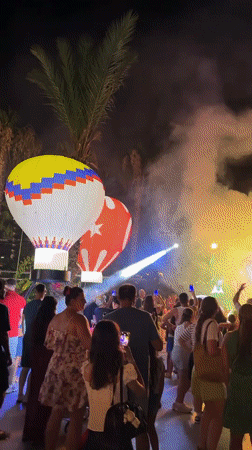 Inflatable hot air balloons light up a poolside night event in Manavgat