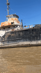 Rusted tugboat documented along Argentine riverbank in Rincón de Milberg
