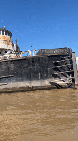 Rusted tugboat documented along Argentine riverbank in Rincón de Milberg
