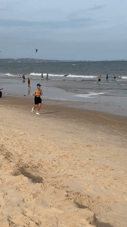 Overcast morning at Mũi Né beach, full of activity and kites
