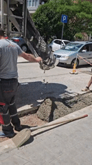 Construction crew repairs sidewalk with concrete mixer truck