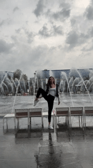 Acrobatic split at a Moscow fountain on a summer day