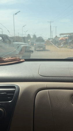 Ambulance spotted on Nigerian road through cracked windshield