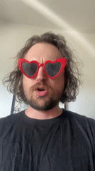 Man in heart sunglasses exercises with dumbbell in Шебунино