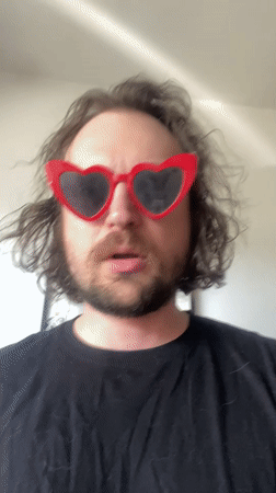Man in heart sunglasses exercises with dumbbell in Шебунино