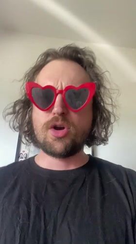 Man in heart sunglasses exercises with dumbbell in Шебунино