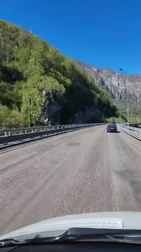 Vehicle crosses textured bridge in mountainous Monastyr, Russia