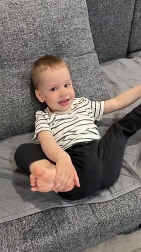 Toddler plays happily on couch in Rusanovo home