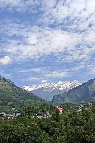 Snow-capped valley, riverside village, and truss bridge in Kulang