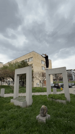 Parkour performer jumps between concrete structures in Shumen
