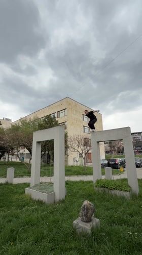 Parkour performer jumps between concrete structures in Shumen