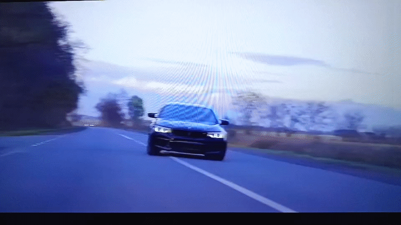 Black BMW travels rural road in Nizhnevartovsk under overcast skies