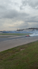 Red sports car practices drifting on Ostrovtsy race track