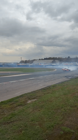Red sports car practices drifting on Ostrovtsy race track