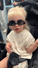 Child in sunglasses spotted in stroller on Tel Aviv train