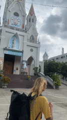 Woman visits church in rainy Đồng Nai, Vietnam