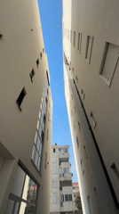 Looking up between two modern buildings in Bar, Montenegro