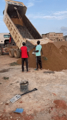 Construction workers oversee sand delivery in Angwan Sayawa, Nigeria